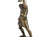 an image of a bronze statue of a man holding a lamp