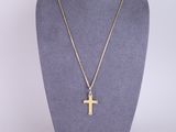 a gold cross necklace on a mannequin mannequin mannequin mannequin mannequin mannequin mannequin mannequin manne