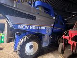 a tractor that is parked in the dirt