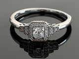 a picture of a diamond ring on a black surface