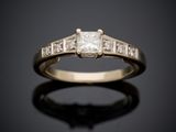 une bague de fiançailles ornée de trois diamants taille princesse sur un fond noir