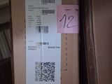 a cardboard box with a barcode on it and a sticker on it