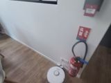 a room with a fire extinguisher and a fire hydrant on the floor