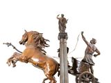 a bronze statue of a horse and carriage with a man on it