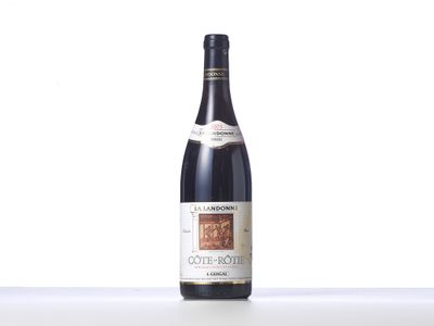 a bottle of wine sitting on top of a white table