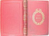 an old book with a red cover and gold lettering on it