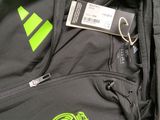 the back of a black jacket with a green logo on it