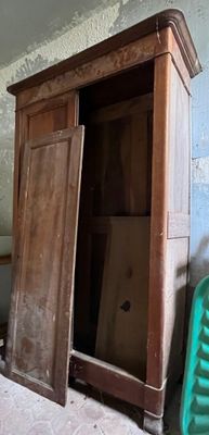 an old wooden cabinet in the corner of a room
