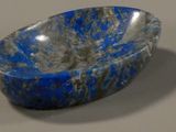 a blue bowl sitting on top of a white table