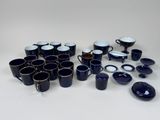 a lot of coffee cups and saucers on the table