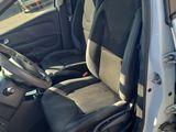 the interior of a car with the door open and the driver ' s seat up