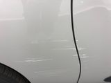 a close up of a white car with the door handle missing