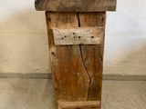 a small wooden stool with a wooden seat on it