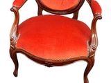 a red chair with a foot stool next to it