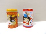 two tins with cartoon characters on them sitting on a table