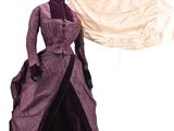 a dress on a hanger next to a dress on a mannequin