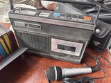 a radio and a microphone on a table next to a purse