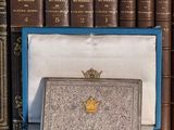 a blue box with a gold crown on top of it