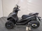 a scooter that is parked on a checkered floor