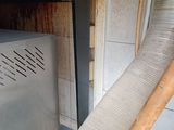 a metal oven with a metal door and a wooden handle