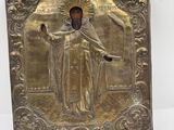 une plaque métallique représentant Jésus tenant une croix