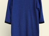 an image of a blue sweater hanging on a hanger
