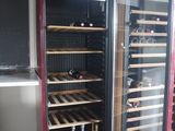 a wine cooler with a lot of bottles inside of it