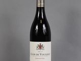 a bottle of red wine sitting on top of a table