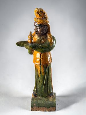a statue of a man holding a bird on a plate