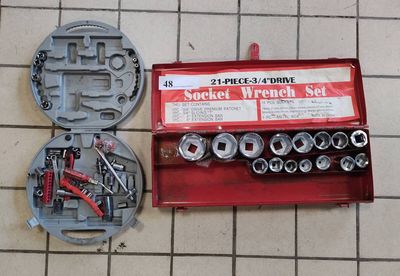 a box of tools on the floor next to a wren set