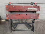 a close up of a metal work bench on a concrete floor