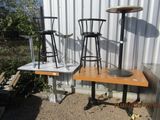 a table with chairs and a table with stools in front of a building