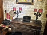 a picture of a room with a desk and a clock on the wall