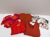 a lot of clothes that are on a white table
