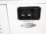 a white machine with a clock on the side of it
