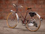 a bike that is parked in front of a brick wall