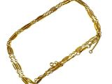 a close up of a gold chain bracelet on a white background