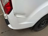 a close up of a white truck parked in a parking lot