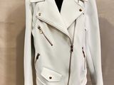 white leather jacket on a mannequin stand on a white background
