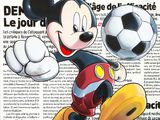 the cover of a magazine with a cartoon mickey mouse kicking a soccer ball