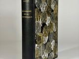 a black book with gold and silver designs on it