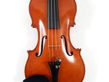 an old violin sitting on top of a white surface next to a bow
