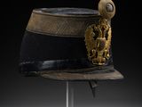 a black and gold hat with a gold emblem on it