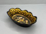 an image of a black and yellow bowl with a picture of a man and a woman on it