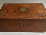 an old wooden box sitting on top of a white table