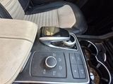 a close up of a car ' s center console with a cell phone in it