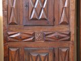 a large wooden door with a decorative design on it