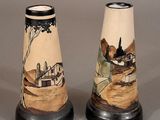 two vases that have been painted with a landscape on them