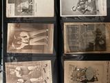 a lot of old photos on display in a glass case