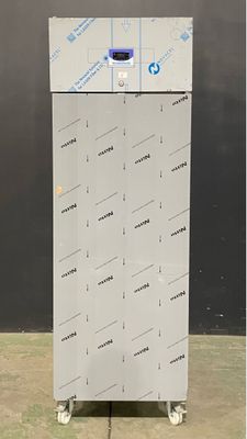 an image of a white refrigerator sitting on top of a cement floor